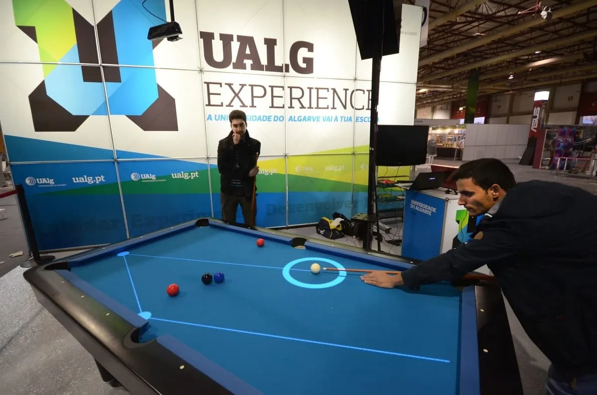 A player lining up a shot while Pool Live AR projects the predicted trajectory onto the table