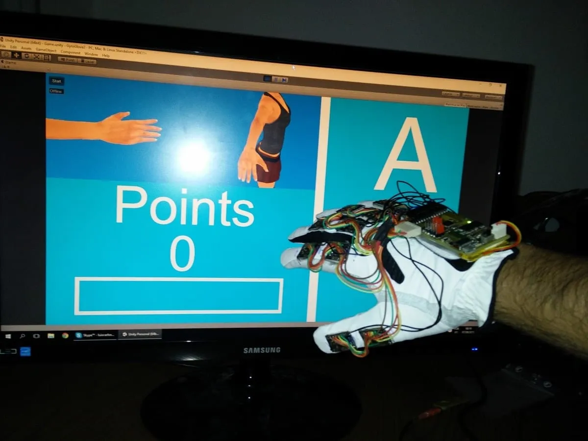 Playing a sign-language game with the Gyro Glove in front of a monitor