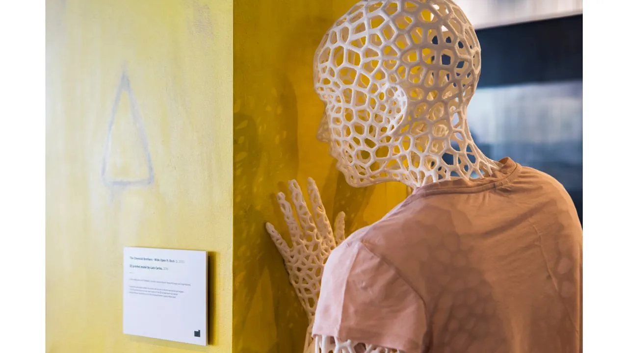 Close-up of the lattice dancer's head against a yellow wall
