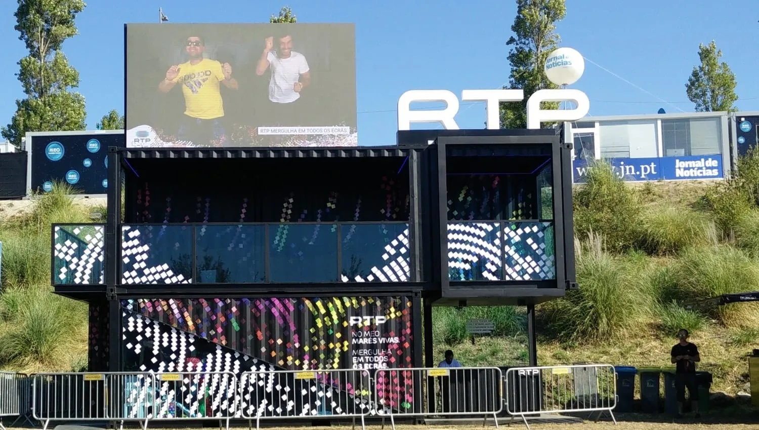 The RTP container booth with its giant screen at the festival