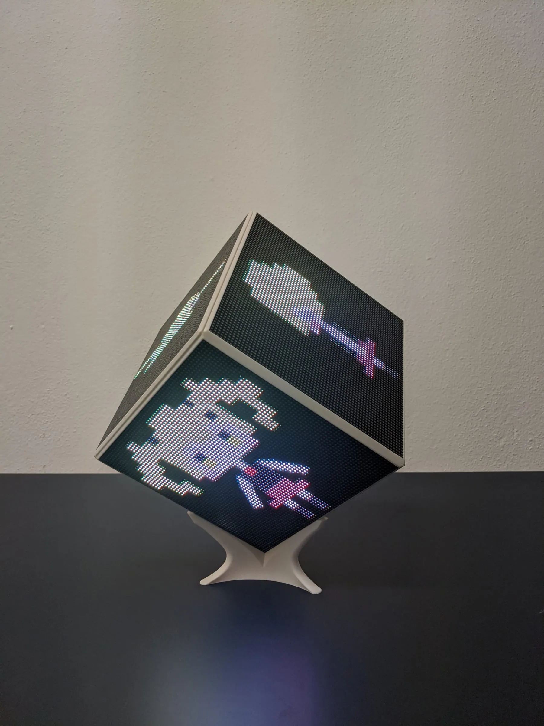 The LED CUBE balanced on one corner on its stand