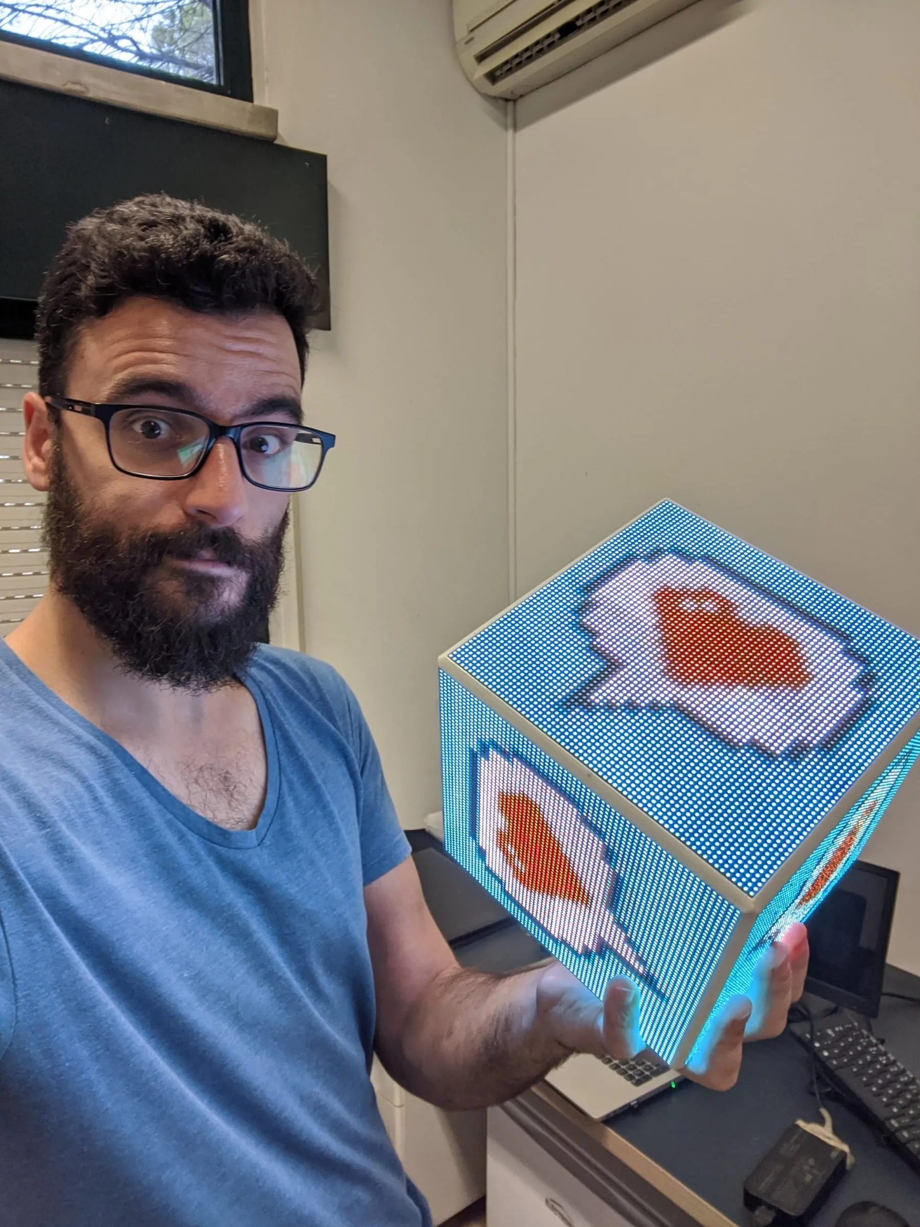 Holding the LED CUBE while it shows a speech-bubble animation