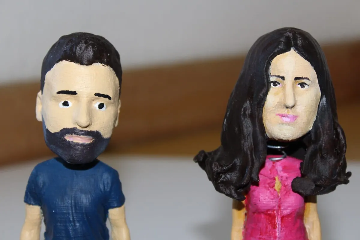 Close-up of the two hand-painted bobblehead faces