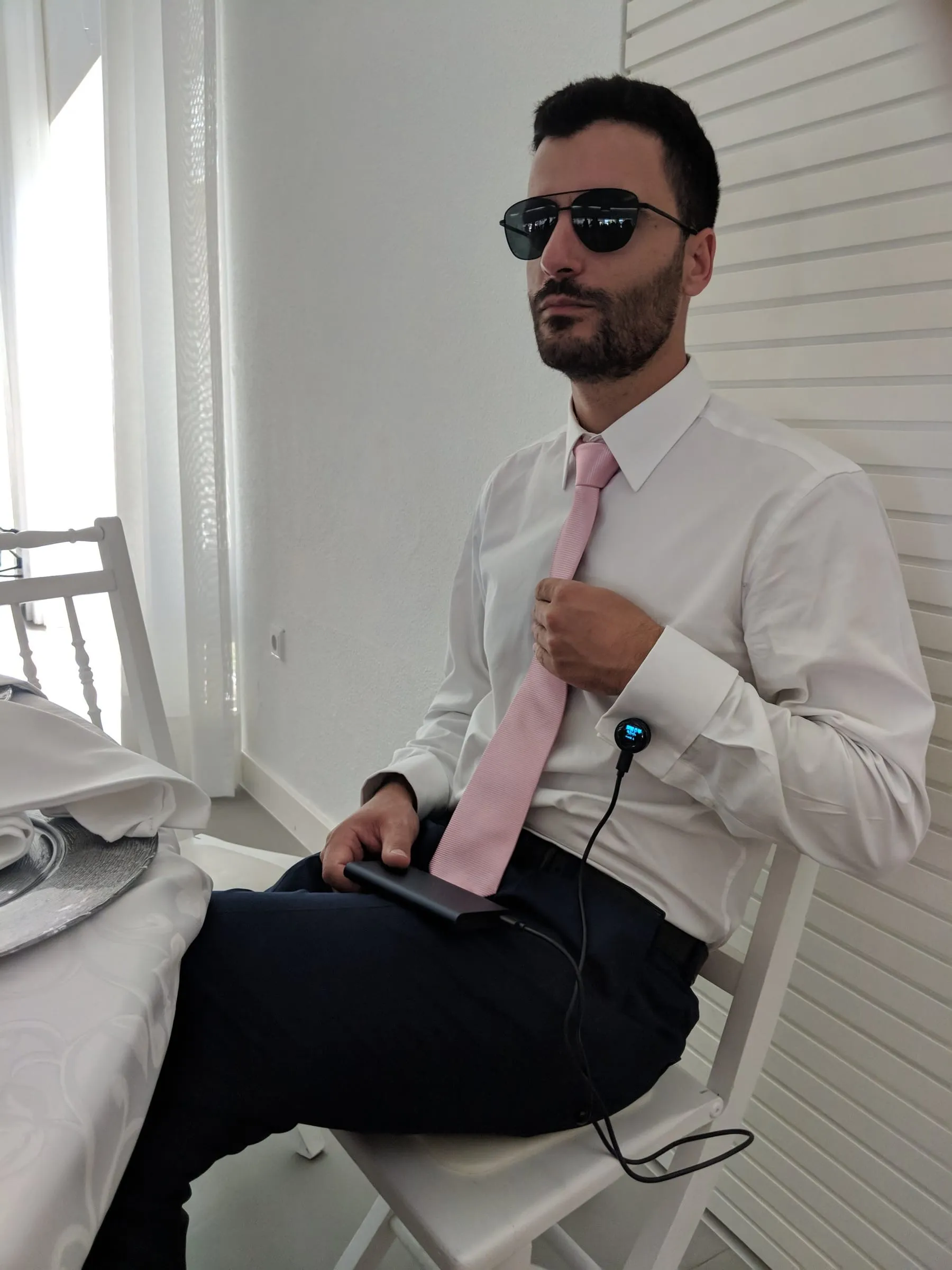 Showing off the cufflinks, sitting down