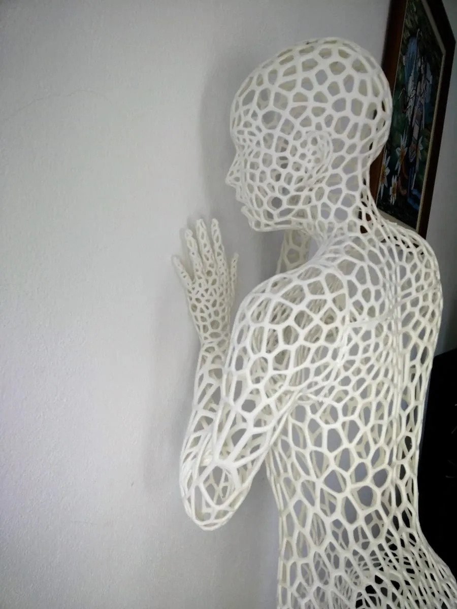 The finished dancer leaning against a white wall
